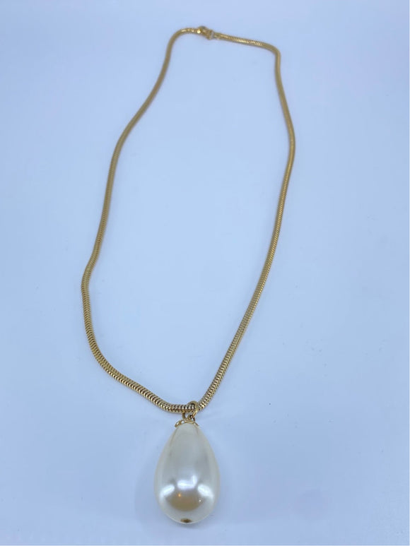 Long gold necklace with a single faux pearl drop.