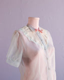 1950's Baby blue sheer top w/lucite buttons & pink bow tie