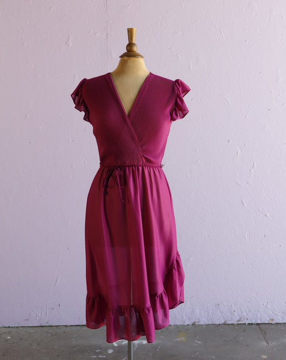 1970's Magenta dress with ruffle sleeves, elastic waistband, faux wrap bodice and asymmetrical ruffle hem.