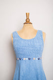1990's Denim baby doll sleeveless mini dress with a smock bodice and daisy appliques