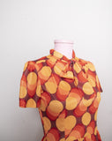 1970's inspired Brown and orange short sleeve mini dress with bow tie in a abstract circular print