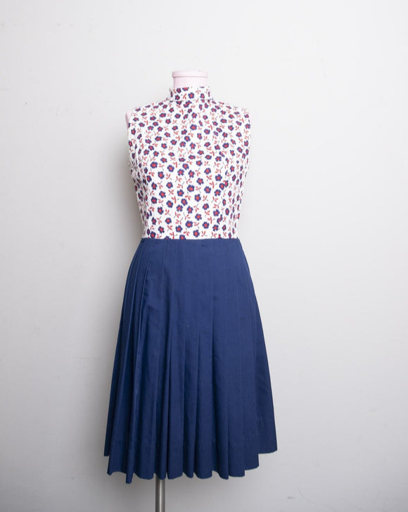 1960-70’s White sleeveless cotton mini dress with a red floral print & navy box pleated skirt
