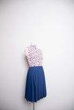 1960-70’s White sleeveless cotton mini dress with a red floral print & navy box pleated skirt