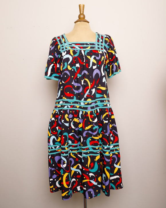 1990's Black Muumuu Midi dress with primary colored celebration confetti print and bell sleeves with pockets
