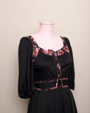 1970's Black prairie style puff sleeve dress with floral trim and corset lacing on bodice