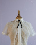 1950's Strutwear White sheer laced ruffle top w/lucite buttons & black bowtie