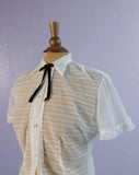 1950's Strutwear White sheer laced ruffle top w/lucite buttons & black bowtie